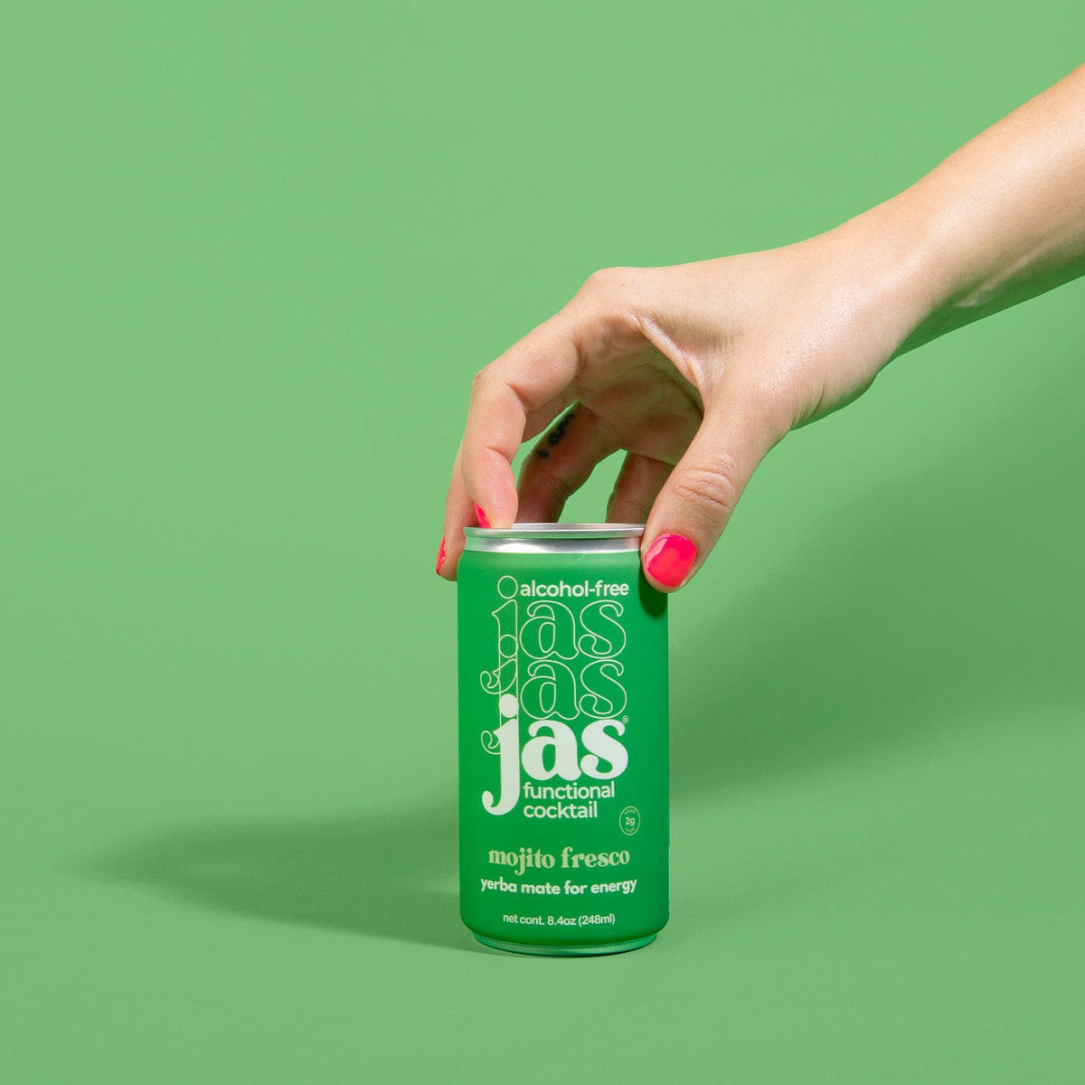 Holding a can of JAS Mojito Fresco made with yerba mate